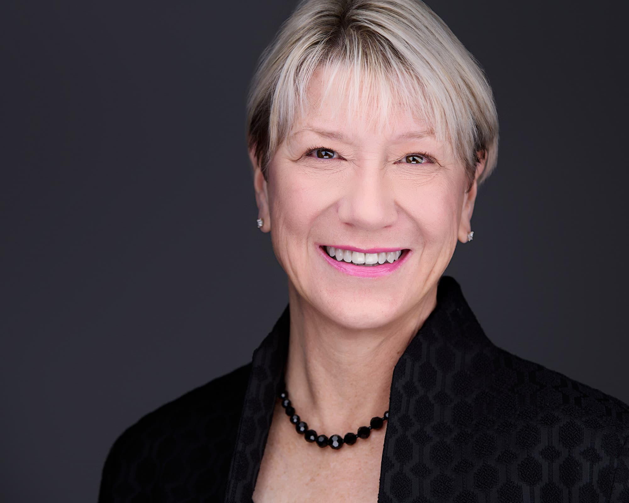 Headshot poses female - confident executive smile