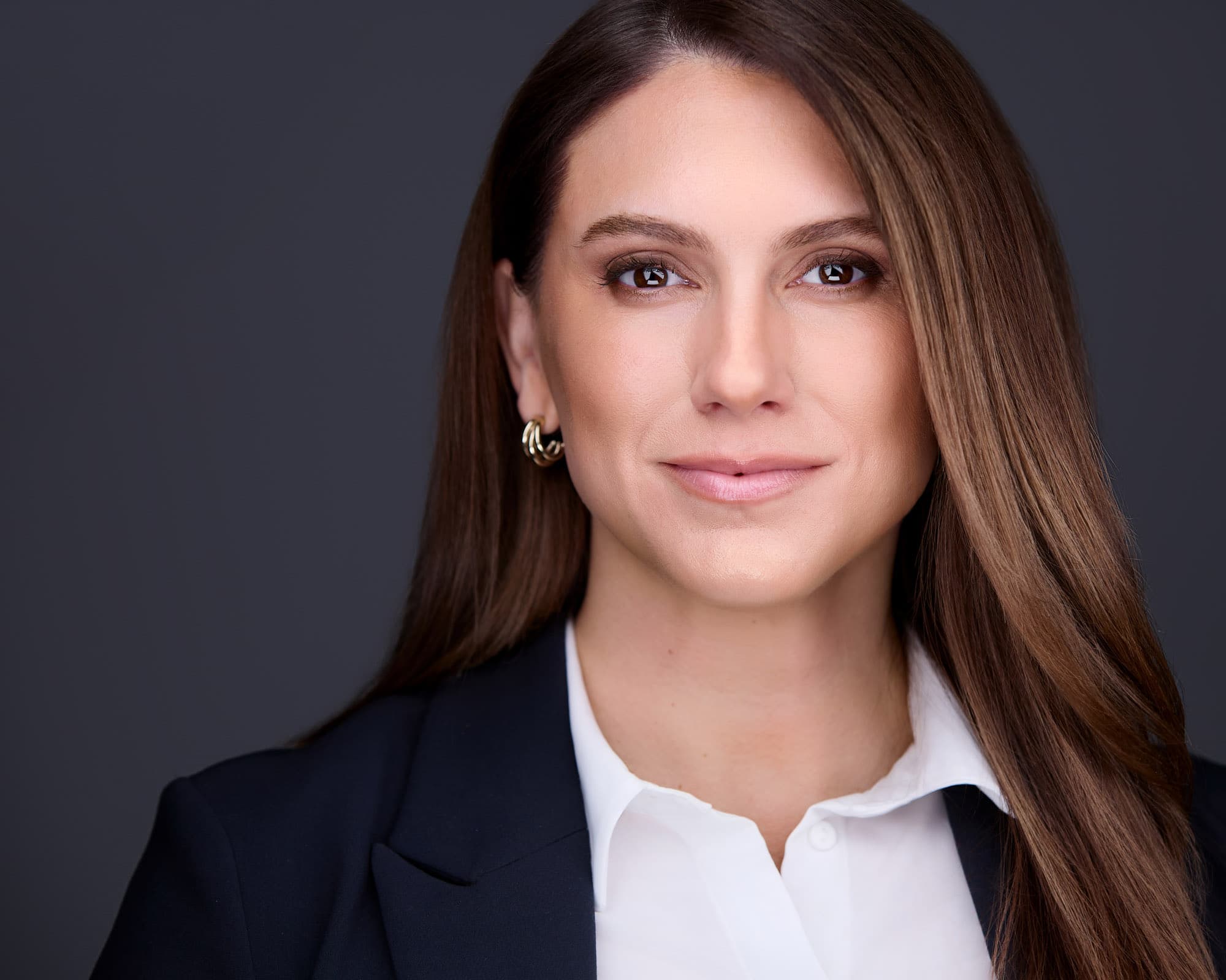 Professional woman headshot with long polished hair