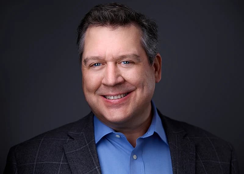 Professional headshot with friendly smile