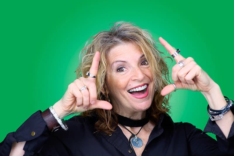 Professional headshot with green background