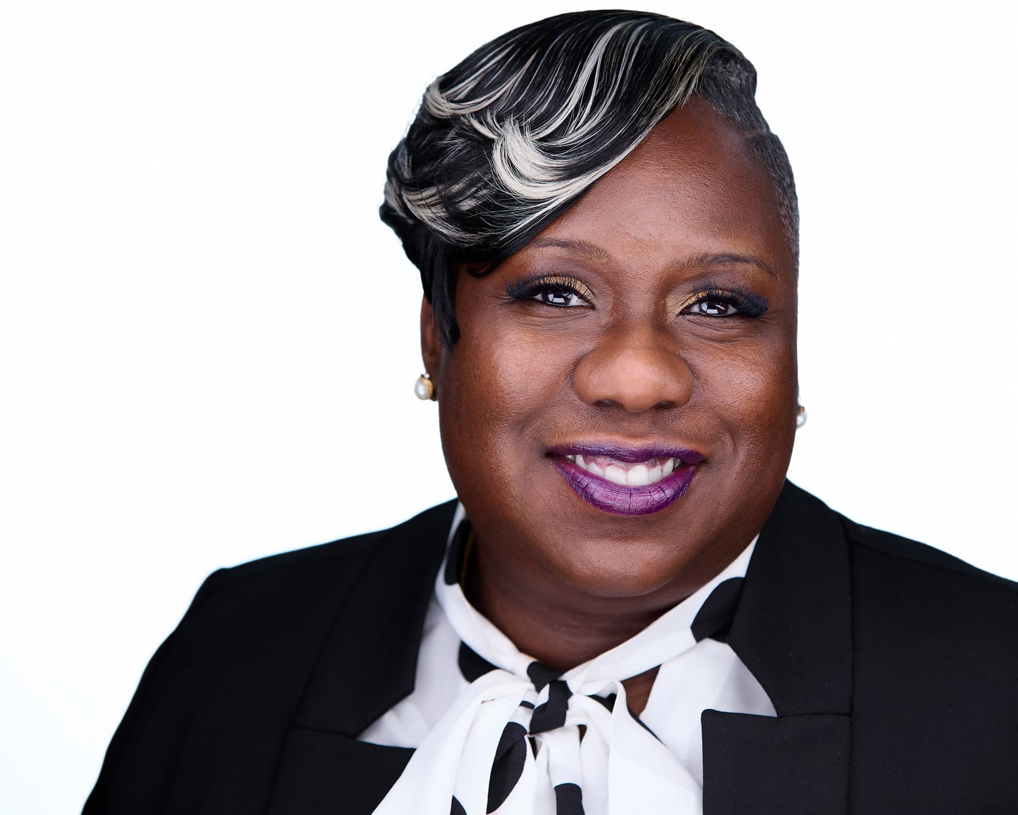 Business headshot of woman in stylish green outfit