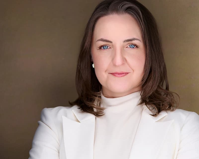 Professional headshot of woman in white blazer in Pittsburgh studio