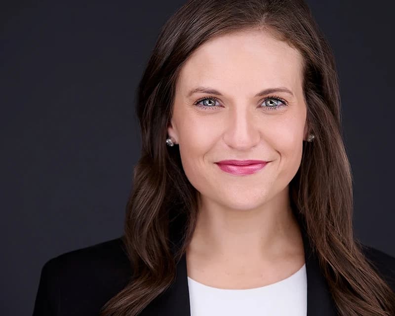 Professional LinkedIn headshot with gray background