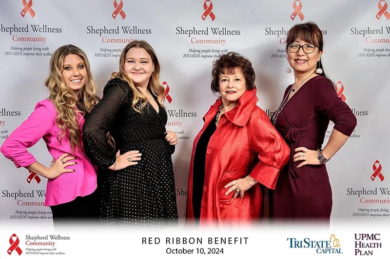 Nonprofit fundraising gala attendees at elegant step and repeat photo station