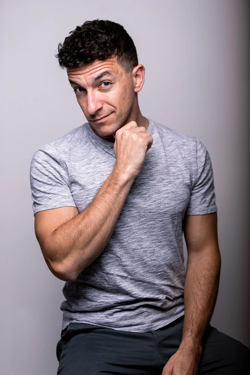 chad isaiah sitting for a mens portrait wearing a gray shirt in the studio