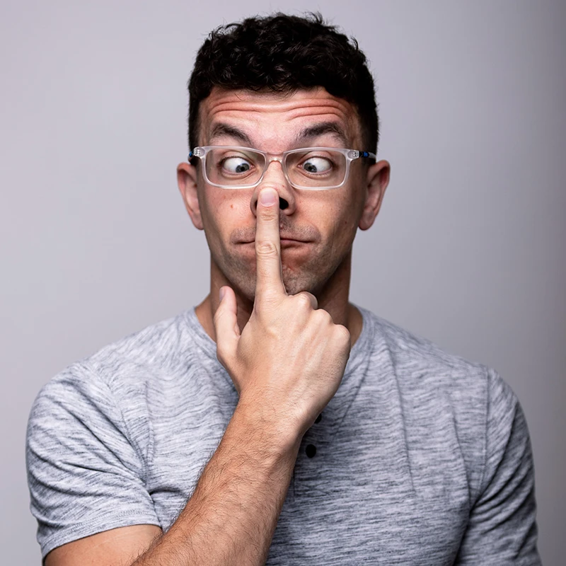 Pittsburgh photographer Chad Isaiah in a gray shirt, playfully cross-eyed and poking his nose, showcasing his fun personality