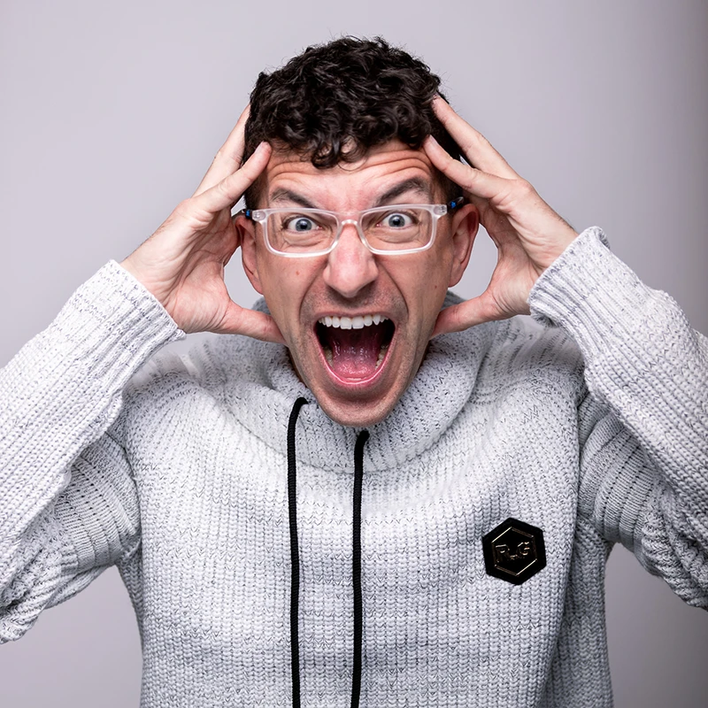 Pittsburgh headshot photographer Chad Isaiah screaming playfully with hands by his head, wearing a white sweater