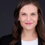 Professional headshots of a smiling nonprofit executive director in a tailored black suit and crisp white shirt.