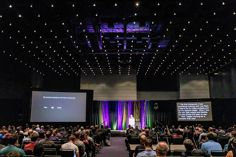 Wide shot example of convention photography for speakers and audience hall