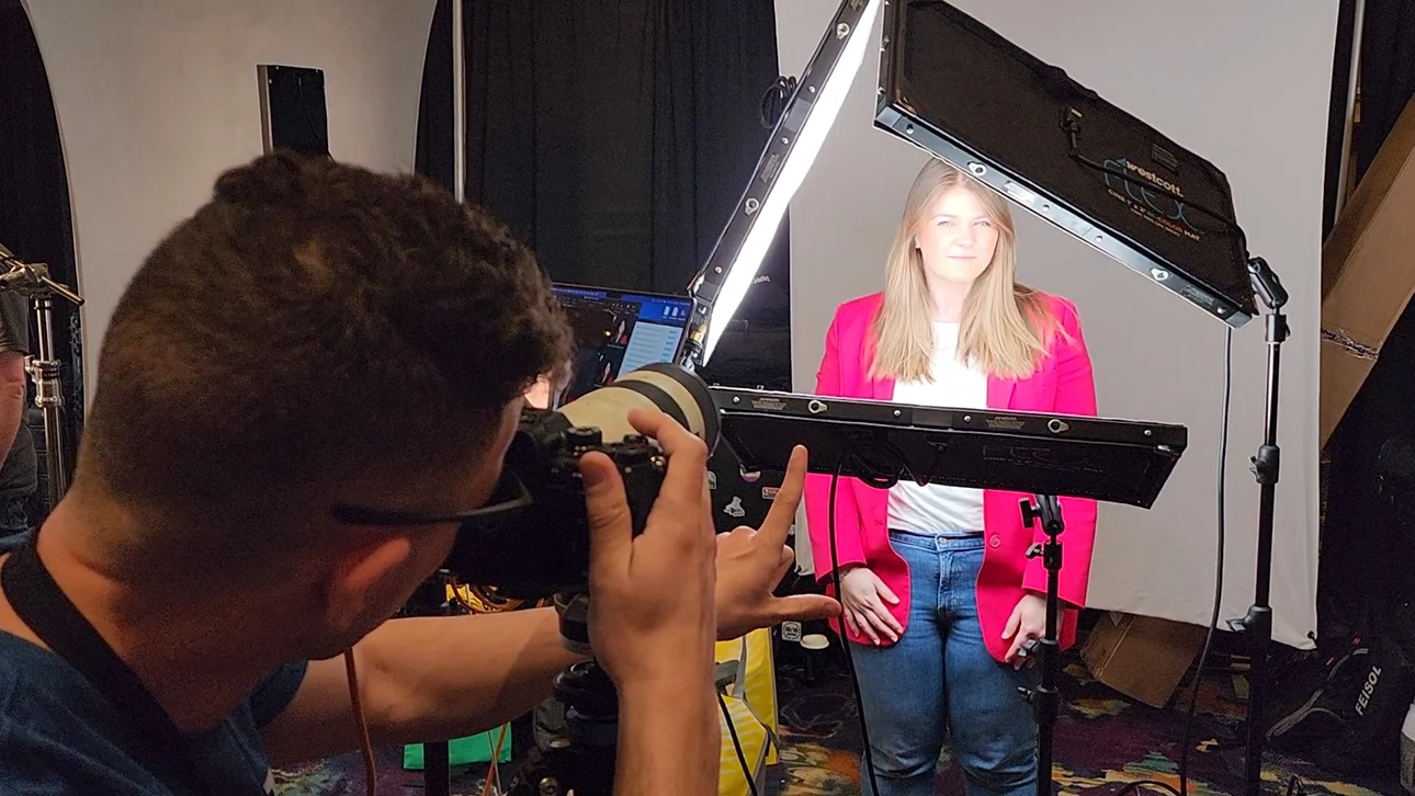 A professional woman in a pink blazer and white shirt poses for some corporate headshots