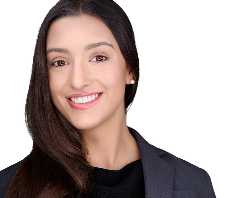 headshot of a white woman with a grinning smile for a job application