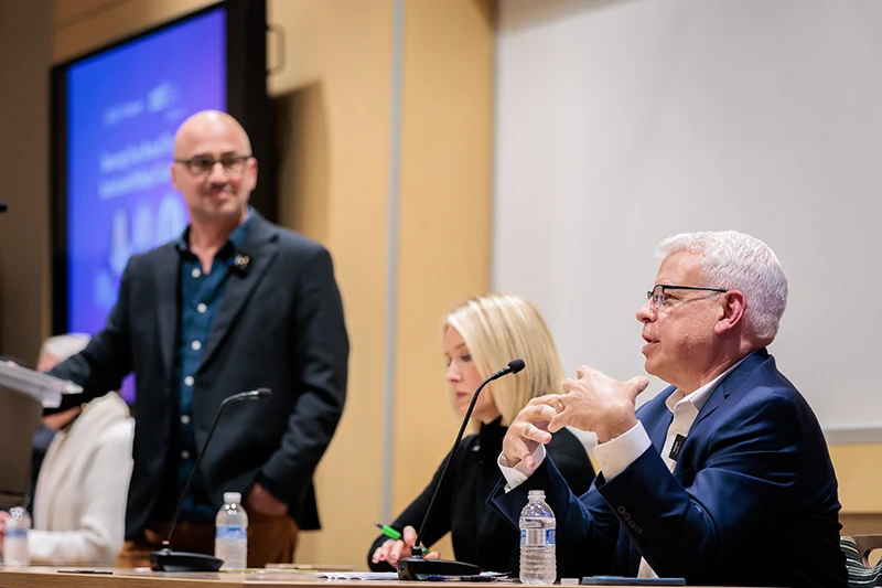 Panel speakers with moderator at American Marketing Association event discussing political issues