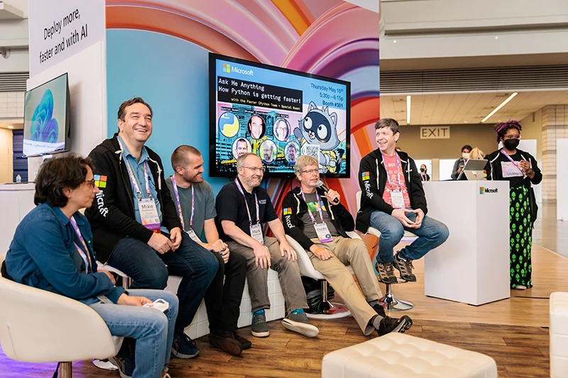 Python experts seated at the Microsoft Trade Show Booth at Pycon discussing AI topics