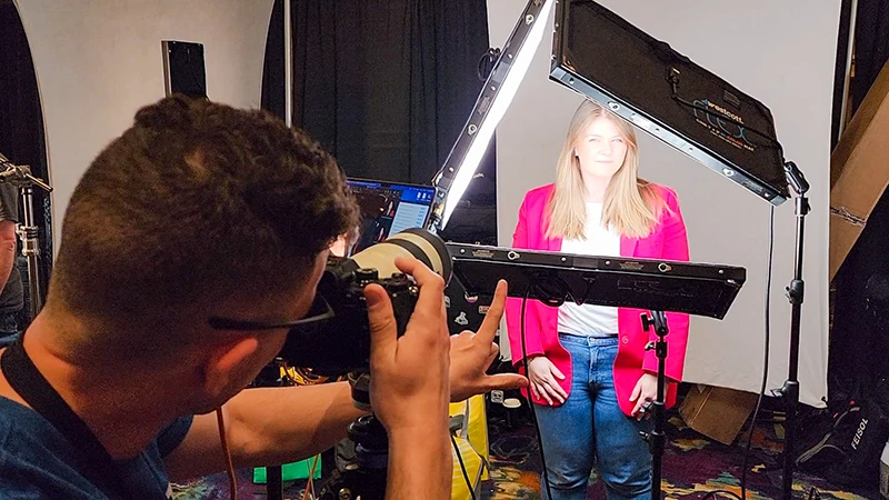 Chad Isaiah directing a client at a conference headshot booth in Las Vegas