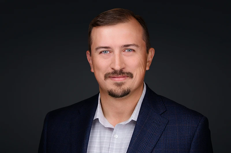 headshot of a white male wearing a blue jacket