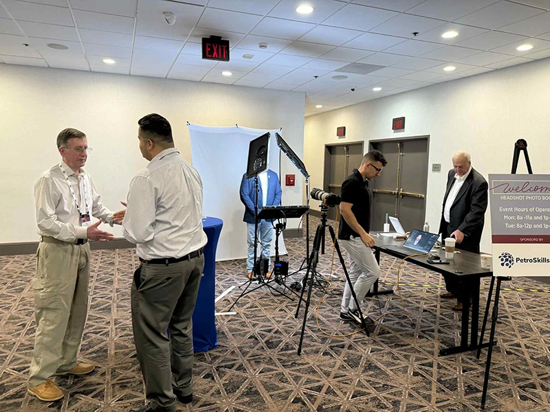 chad isaiah working the gpa midstream headshot booth sponsored by petroskills