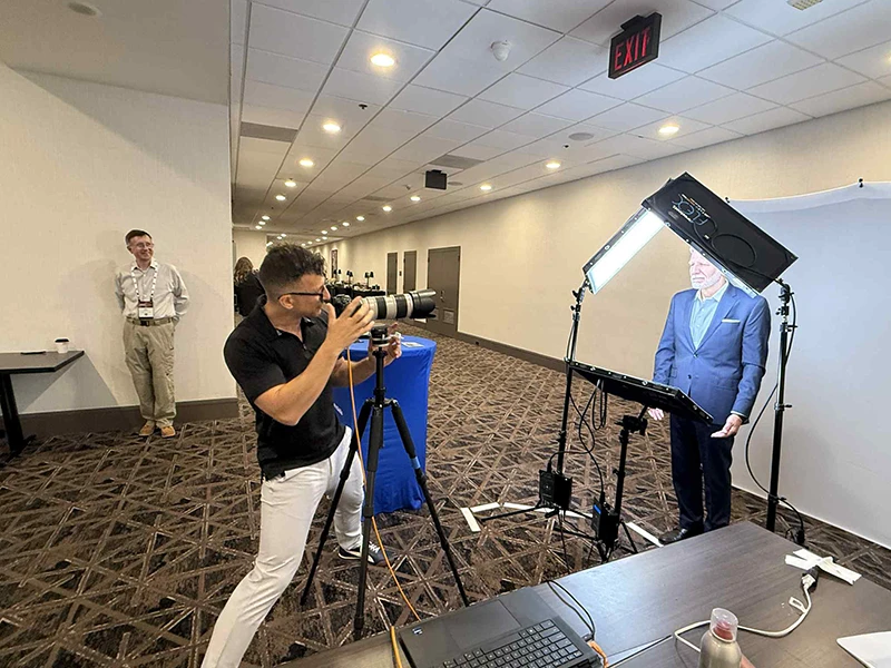 chad isaiah working the gpa midstream headshot booth sponsored by petroskills